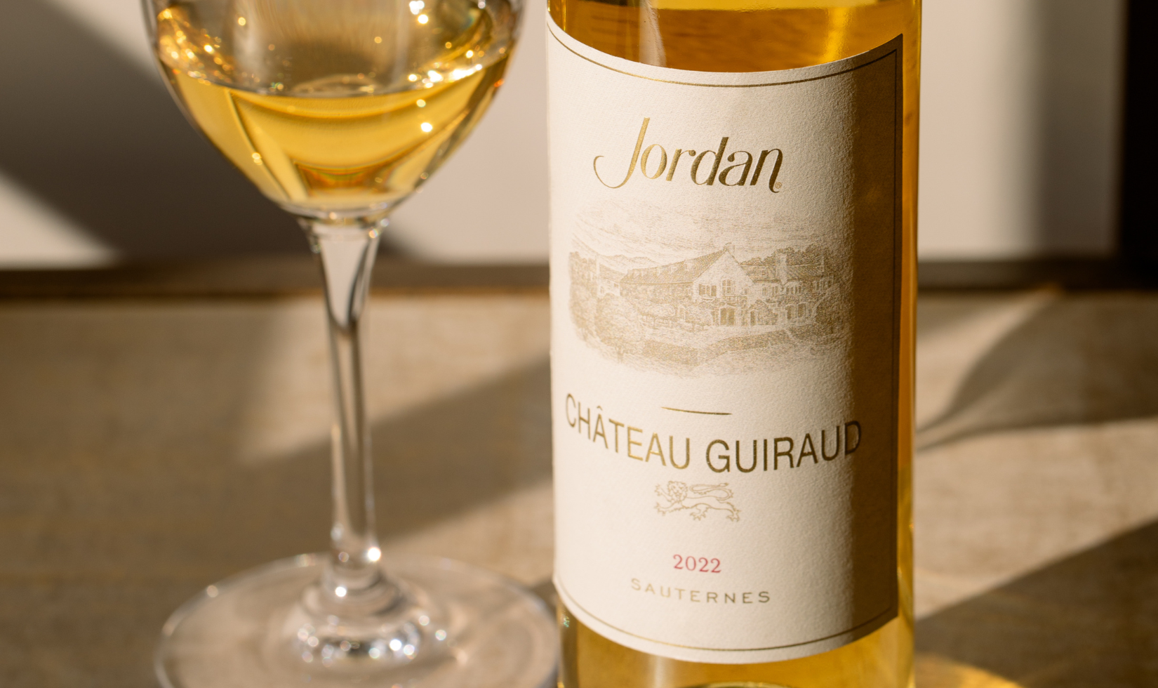 close up on dessert wine label with wine glass of sauternes